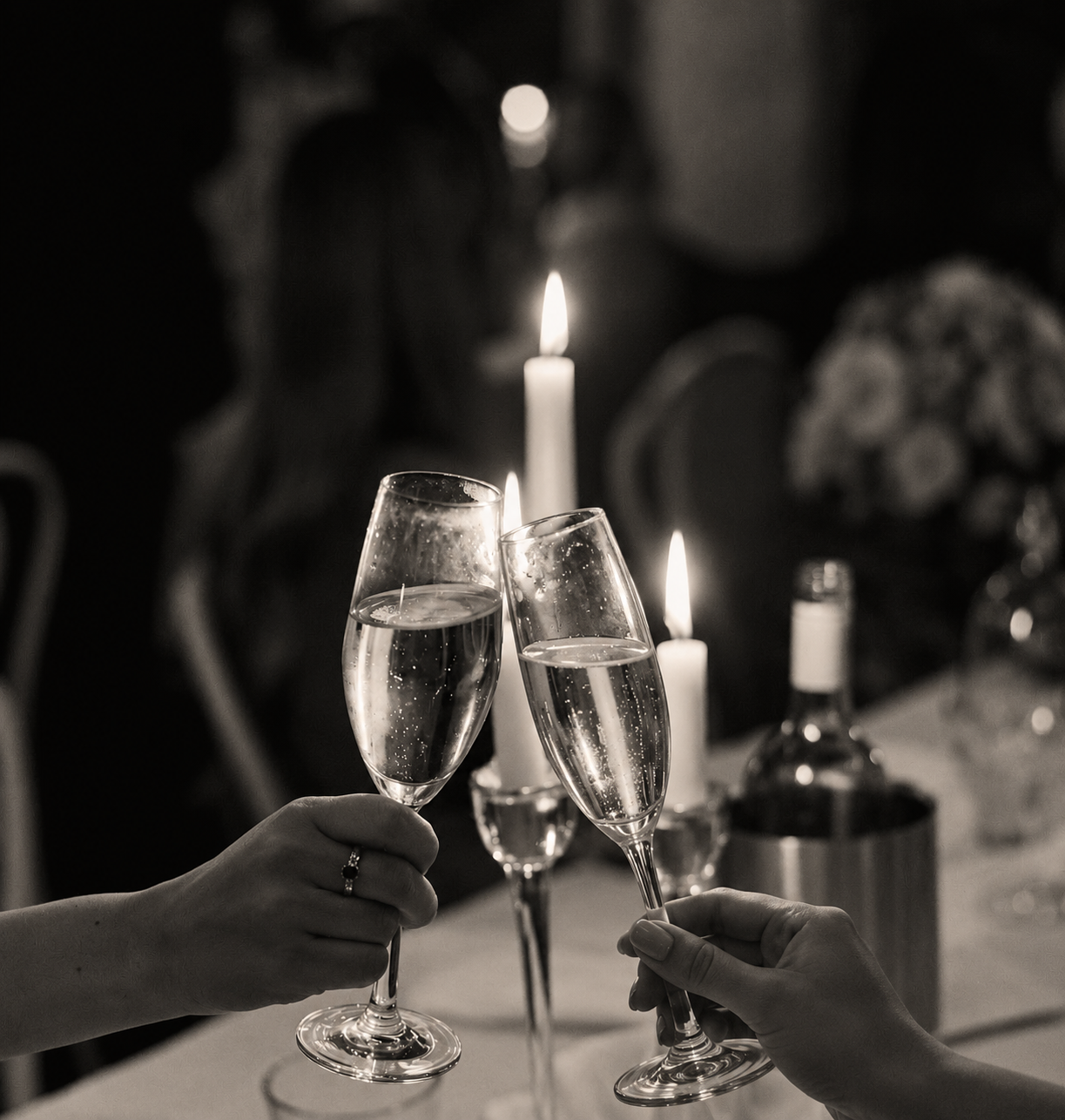 Champagne coupes set on an elegant reception table with flowers